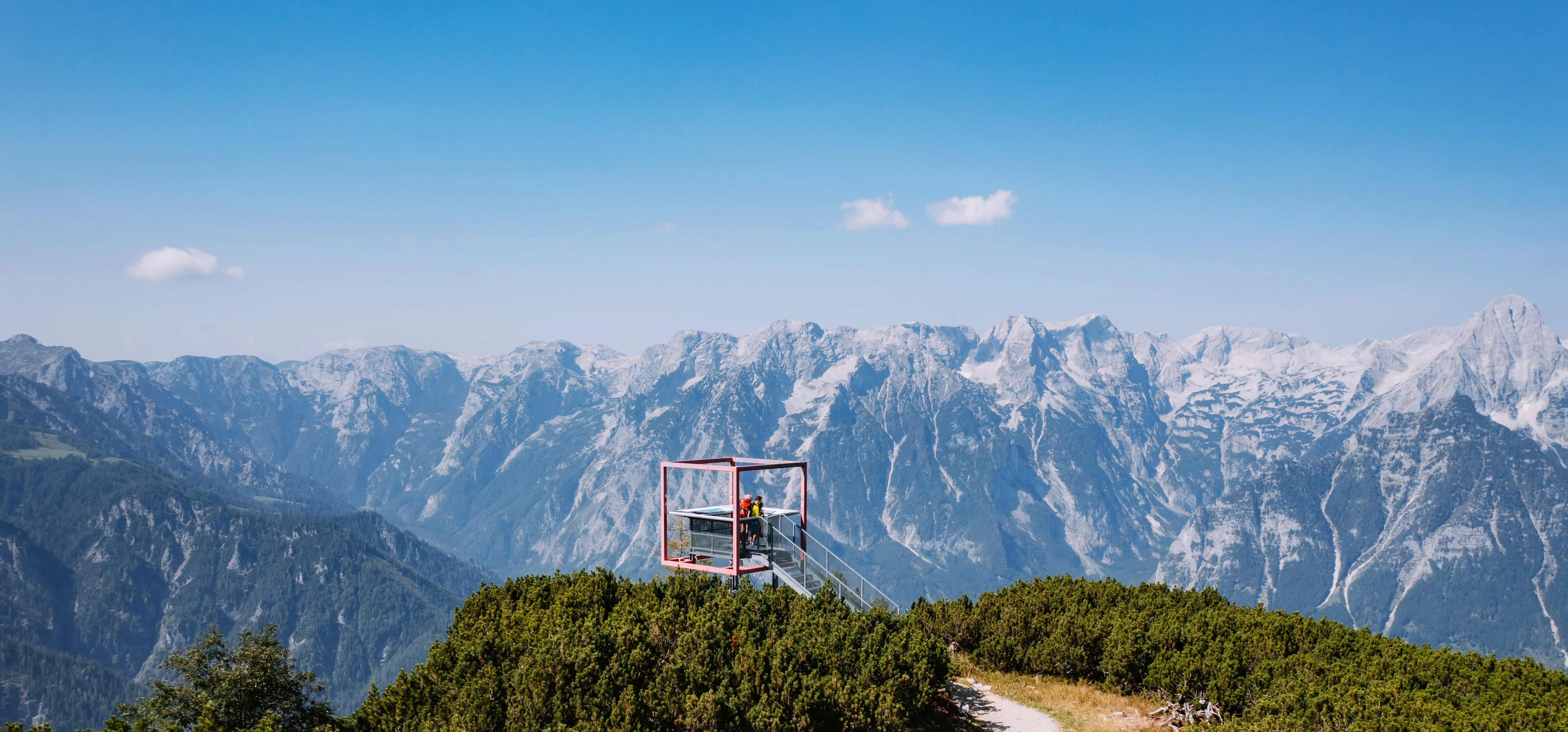 © whatifmedia / Pyhrn-Priel Tourismus GmbH Aussichtsplattform mit rotem Rahmen auf der Höss über Hinterstoder, dahinter die Gipfel des Toten Gebirges